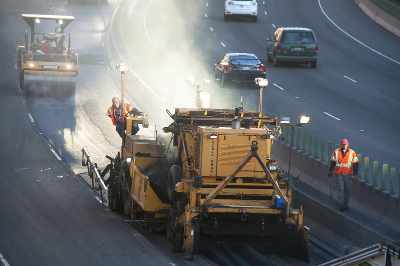 Asphalt paving crew laying a new highway surface